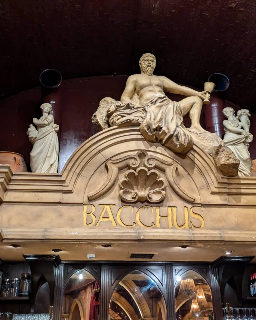 Bacchus statue at top of bar