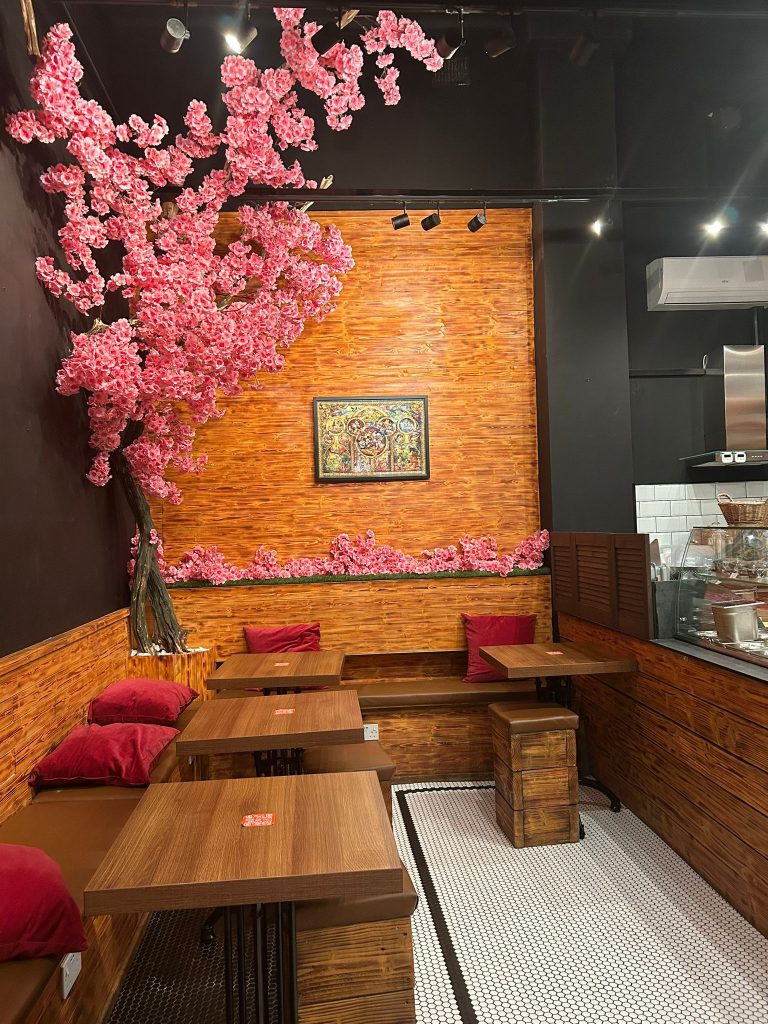 cafe tables with pink blossom tree decoration