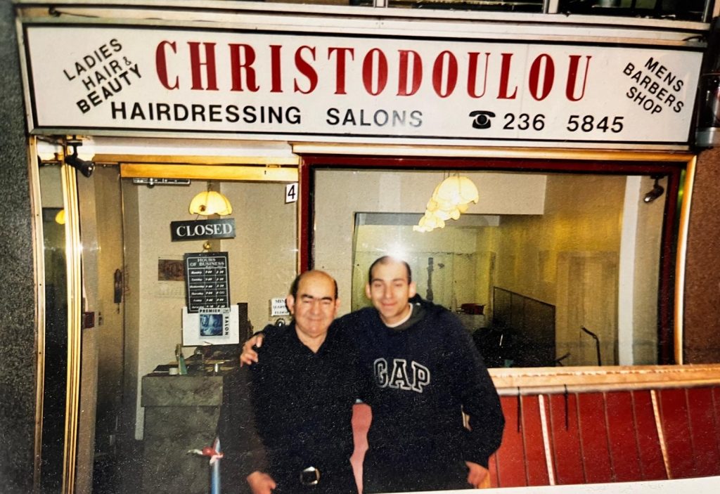 two men in front of barber shop